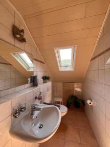 a bathroom with a sink and a toilet at Weingut Zenz-Pohl in Kinheim +50 photos