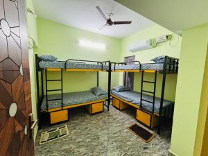 two bunk beds in a room with a ceiling at A2KD Stay - Achyutam Keshavam Krishna Damodaram in Tiruvannāmalai