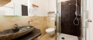 a bathroom with a sink and a toilet and a shower at Der Wieshof in Riedlhütte +59 photos