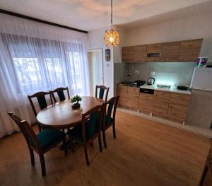 a kitchen and dining room with a table and chairs at Lavanda Lux in Drvar