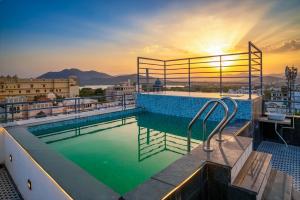 a swimming pool on the roof of a building at UDAISA - The Luxury Art in Udaipur