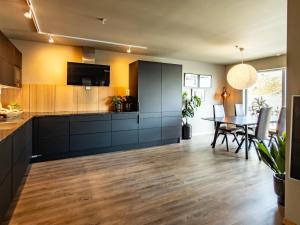 a kitchen with a table and a dining room at Villa Lofoten balcony view in Ballstad
