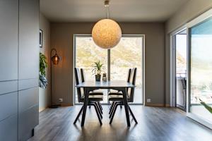 a dining room with a table and chairs at Villa Lofoten balcony view in Ballstad