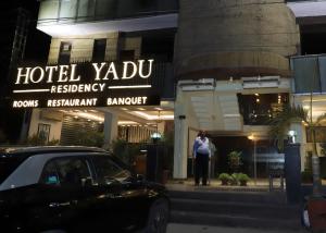 a person standing in front of a hotel yoda restaurant at Hotel Yadu Residency in Meerut +12 photos