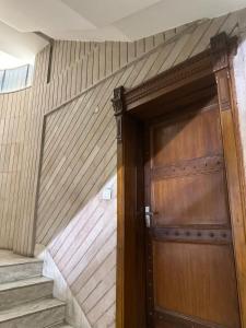 a wooden door on the side of a building at Hotel Yadu Residency in Meerut
