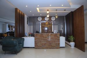 a lobby with a chair and a desk and clocks at yellow apple hotel in Addis Ababa