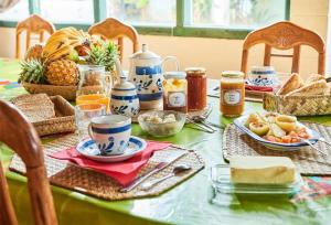 a table with a green table with food on it at chez mamie in Les Avirons +15 photos