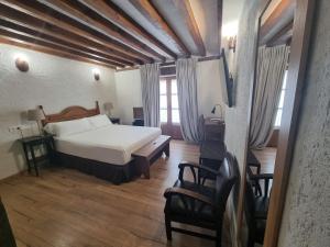 a bedroom with a bed and a table and chairs at Hotel Labranza in San Martín de Valdeiglesias +69 photos