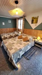 a large bedroom with two beds in a room at chez mamie in Les Avirons