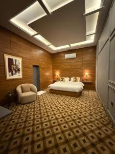 ein Hotelzimmer mit einem Bett und einem Stuhl in der Unterkunft Hotel Vintique in Lahore