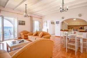 a living room with a couch and a table at SeaView Calypso in Nisaki