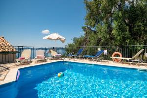 a pool with chairs and a ball in the water at SeaView Calypso in Nisaki