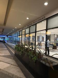 a man walking in front of a building at Resorts World Eighty One Newport Boulevard Near Airport T2 and T3 in Manila +8 photos