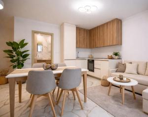 a kitchen and living room with a table and chairs at SoleMare Luxury 2 Bedroom Apartment in Aheloy
