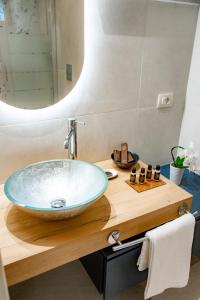 a bathroom with a large bowl sink on a wooden counter at Relais VILLA CAIA in Noto +16 photos