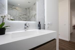 a white bathroom with a large white sink at Serena By Marenssa in Moncarapacho +9 photos