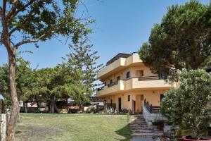 a large building with trees in front of it at Kreta Natur Live Crete Naturally in Hersonissos