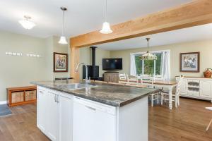 a kitchen and dining room with a large counter top at Ideal getaway - Ideal retreat in Lac-Brome