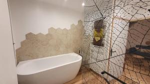 a bathroom with a white bath tub in a room at T'nature à Château Chalon in Château-Chalon