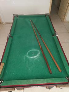 a pool table with chopsticks on top of it at Casa 70 Hostel 350m da praia Balneario Flamingo in Matinhos