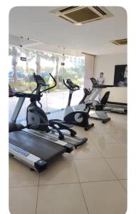 a gym with several tread machines in a room at The Aura stays in Indore