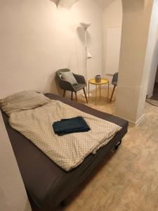 a bedroom with a bed and a chair and a table at Jüstel apartment in Litoměřice