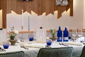 a table with blue bottles and glasses on it at Der Wieshof in Riedlhütte
