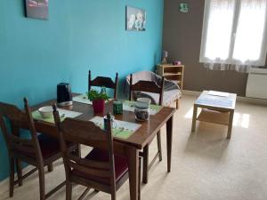 a dining room with a wooden table and chairs at Chez Mimi in Châtillon-sur-Seine
