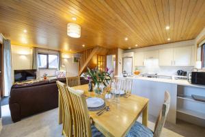 a kitchen and dining room with a table and chairs at E42 - Nare in Truro