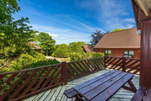 a wooden deck with a bench on a house at E42 - Nare in Truro