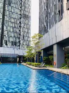 a large swimming pool in front of a tall building at Star Residence KLCC By BluekeyKL in Kuala Lumpur