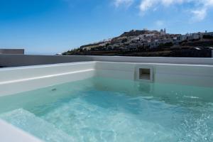 a jacuzzi tub with a view of a city at Sweet nectar villa at Pyrgos with heated jacuzzi in Pyrgos