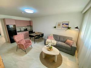 a living room with a couch and a table at Nikol's central suite 1 in Nea Peramos