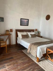 a bedroom with a large bed and a desk at M'Serenity Guest House in Antananarivo