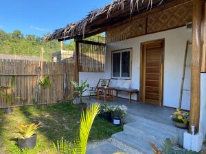 a patio of a house with a bench and a fence at Sunset Garden in San Vicente