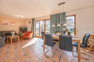 a living room with a table and a dining room at Ferienwohnung Krebs in Loddin