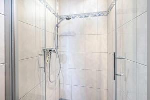 a shower with a glass door in a bathroom at Ferienwohnung Krebs in Loddin +20 photos