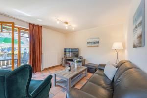 a living room with a couch and a table at Ferienwohnung Wassermann in Loddin