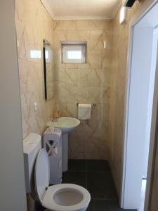 a bathroom with a toilet and a sink at Apartments Suzana in Čapljina +59 photos