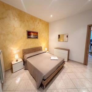 a bedroom with a large bed and two night stands at Fiorucci Apartments - Daniele's House Lago Di Bolsena in Marta