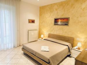 a bedroom with a bed and a window at Fiorucci Apartments - Daniele's House Lago Di Bolsena in Marta +5 photos