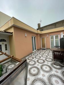 a balcony with a tile floor in front of a house at Areias do Norte in Póvoa de Varzim