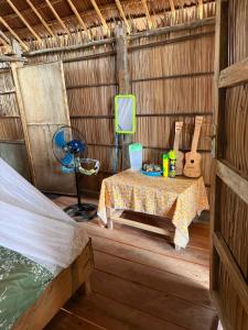 a small room with a table in a hut at West Waigeo Bungalow in Kabu