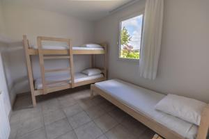 a small room with a bunk bed and a window at Village Beauséjour - Rêves de mer in Le Conquet +56 photos