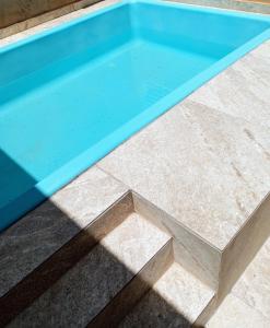 a pool of water sitting on top of a tile floor at Riviera engenharia in Campo Grande