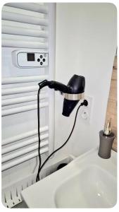 a black lamp sitting on top of a sink at les Renardeaux maison cosy idéal PRO CNPE PIPA et Familles in Ambutrix