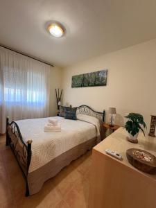 a bedroom with a large bed and a table with at Casa Campanilla in Riumar