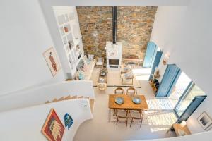 an overhead view of a living room with a brick wall at Ikos Kythnos in Kithnos