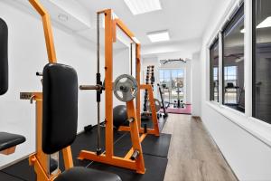 a fitness room with treadmills and a gym at Resort Rybníček in Blatnice