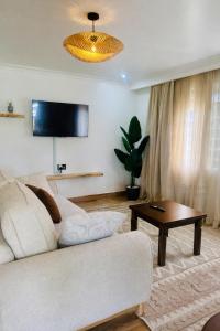 a living room with a couch and a table at Kisii cottage in Kisii